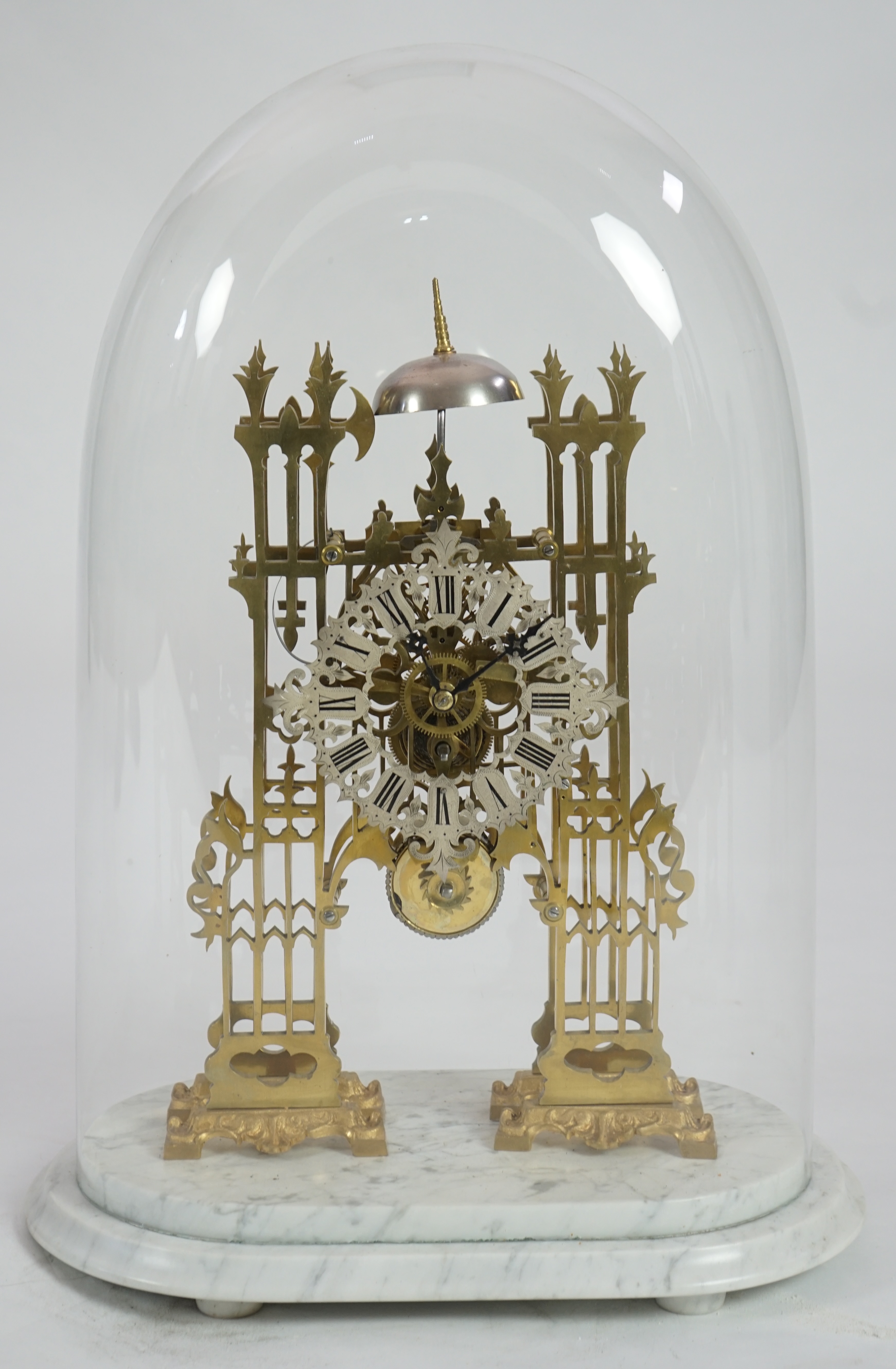 A Victorian brass cathedral front skeleton clock